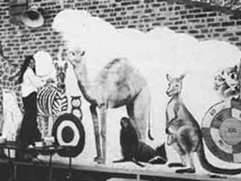 Historical photo of Christine Blundell painting a mural at St Monica's Primary Richmond